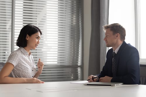 Recruiter listening to young Asian candidate at job interview, confident applicant answering to recruiter questions, introduction, good first impression, recruitment process, human resources